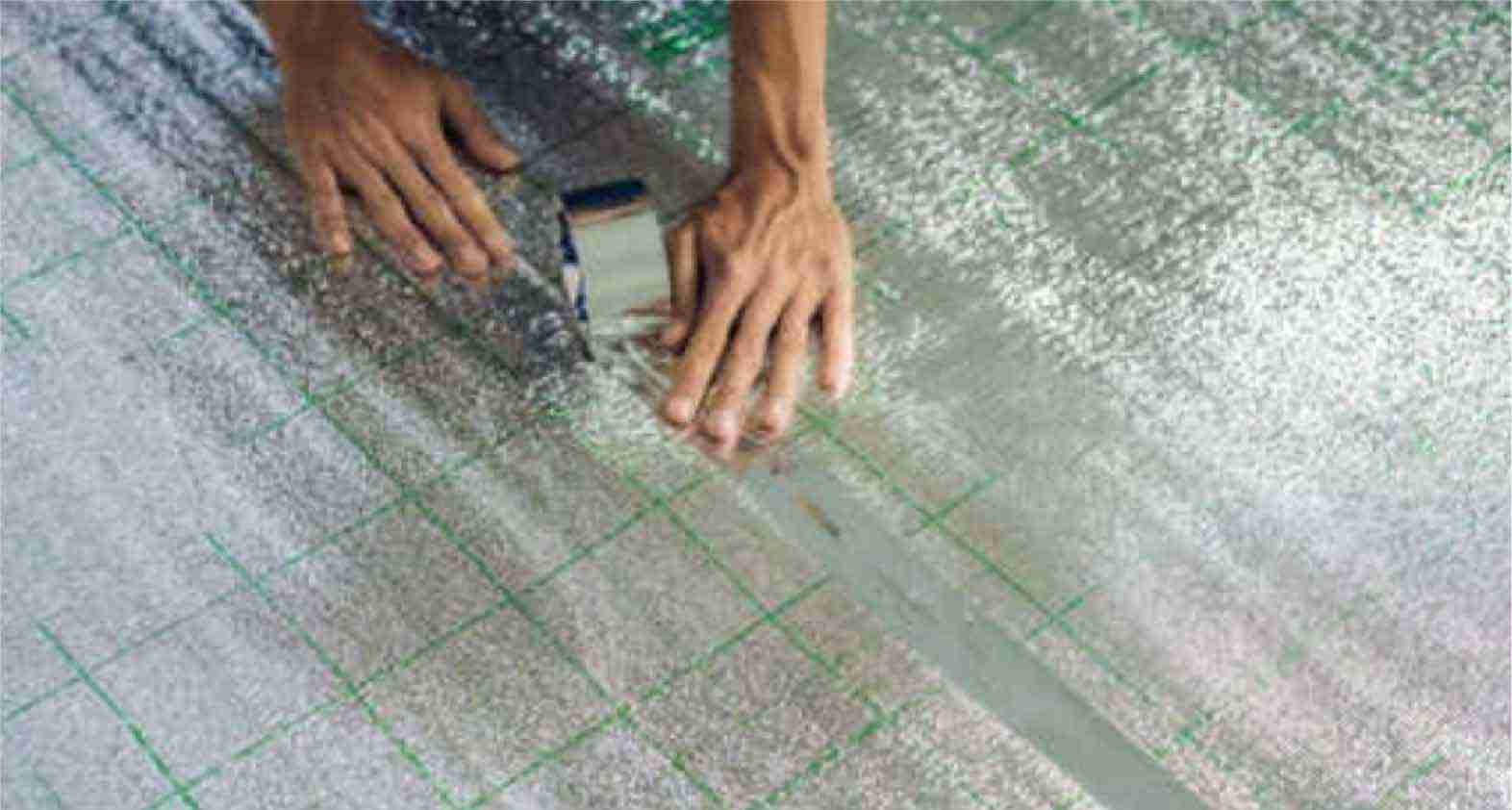Radiant-foil-insulation Two pieces of radiant foil insulation being taped together with duct tape.